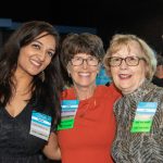 Three Habitat sponsors, Amina, Cathy, and Joy, smile together at 2023's Blueprints and Bubbly event