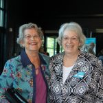 Two women smile together at Habitat Greensboro's Blueprints and Bubbly event.