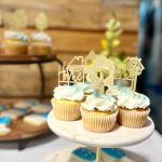 A tray of Habitat Greensboro themed-cupcakes feature blue and gold details