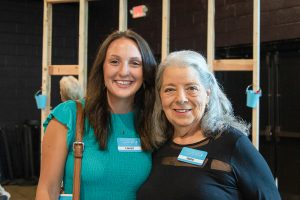 Greenboro Habitat stakeholders Lauryn and Hallie smile side-by-side at the 2024 Blueprints and Bubbly event.