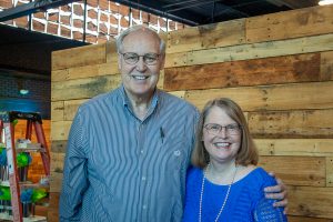 Habitat Greensboro stakeholders Frank and Lisa stand smiling at the 2024 Blueprints and Bubbly event.