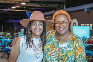 Habitat Greensboro's Christina Simms and Renee Holloway stand together smiling at Habitat Greensboro Blueprints and Bubbly event